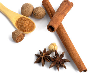 Cinnamon sticks with star anise, nutmeg isolated on white background.