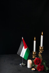 front view of burning candles with palestinian flag on dark background funeral israel
