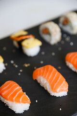 close up of sushi set on dark tray