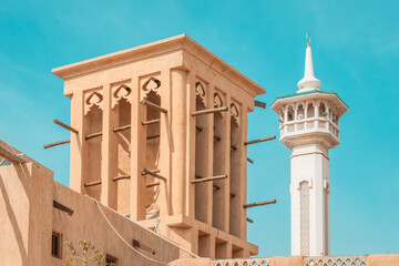 Al Fahidi mosque minaret and traditional arab windtower used for ventilation and air conditioning...