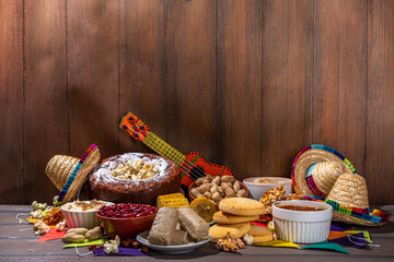 Traditional Festa Junina Summer Festival Carnival Food. Traditional Brazilian Festa Junina dishes and snacks - popcorn, peanuts, corn cake and cookie, pacoca, with holiday decorations and accessories