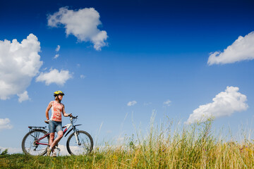 Mountain biking - woman with bike enjoy summer vacation