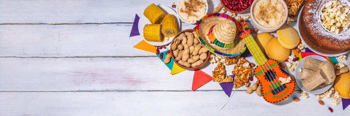 Traditional Festa Junina Summer Festival Carnival Food. Traditional Brazilian Festa Junina dishes and snacks - popcorn, peanuts, corn cake and cookie, pacoca, with holiday decorations and accessories