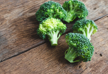 Fresh green broccoli over rustic wooden background