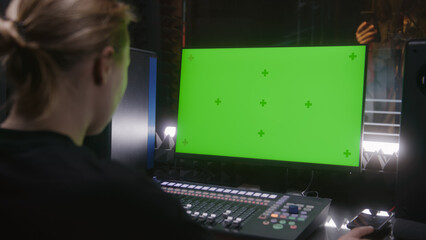 Male singer records song in soundproof room. Female audio engineer, producer uses control mixing...
