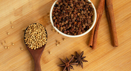 Coriander seeds  anise and cinnamon on wooden table
