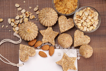 Homemade healthy and sweet groundnut or peanut and Jaggery Laddoo, delicious indian sweet served on a wooden background.Roasted peanut isolated.