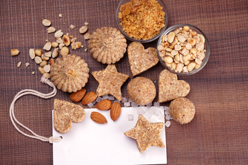 Homemade healthy and sweet groundnut or peanut and Jaggery Laddoo, delicious indian sweet served on a wooden background.Roasted peanut isolated.