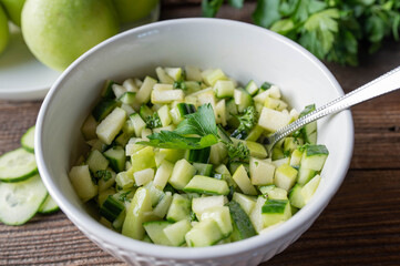 Detox snack with marinated cucumber, green apple salad in a bowl