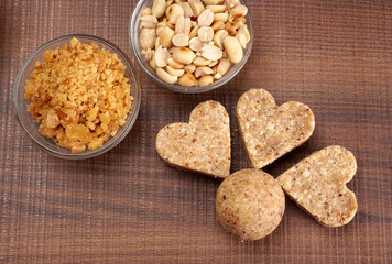 Homemade healthy and sweet groundnut or peanut and Jaggery Laddoo, delicious indian sweet served on a wooden background.Roasted peanut isolated.