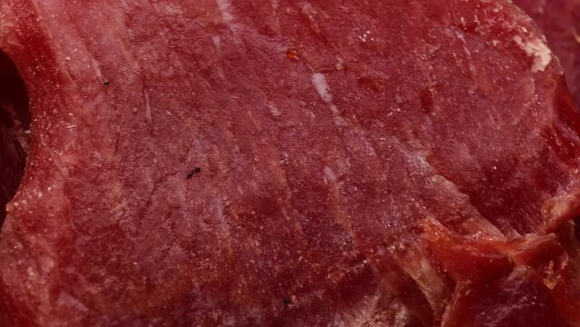 dried pork meat, rotation in circle. meat appetizer for Turning beer. selective focus. macro