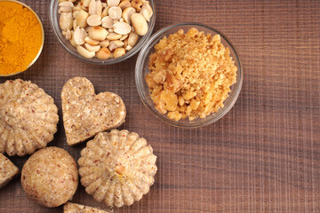 Homemade healthy and sweet groundnut or peanut and Jaggery Laddoo, delicious indian sweet served on a wooden background.Roasted peanut isolated.