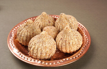 Homemade healthy and sweet groundnut or peanut and Jaggery Laddoo, delicious indian sweet served on a wooden background.Roasted peanut isolated.