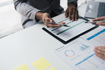 Close up view of investment consultant giving money management plan and advice to his client during th meeting time.