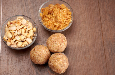 Homemade healthy and sweet groundnut or peanut and Jaggery Laddoo, delicious indian sweet served on a wooden background.Roasted peanut isolated.