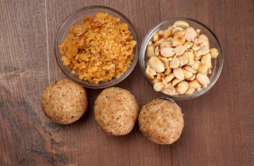 Homemade healthy and sweet groundnut or peanut and Jaggery Laddoo, delicious indian sweet served on a wooden background.Roasted peanut isolated.