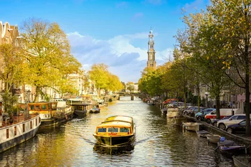 Rolgordijnen Cruise boat navigating Amsterdam canals © Maya Photos