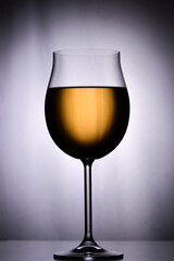 Glass of white wine on  white background