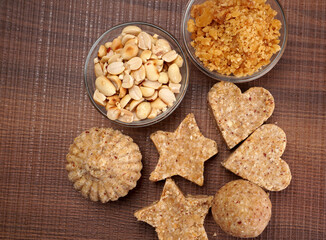 Homemade healthy and sweet groundnut or peanut and Jaggery Laddoo, delicious indian sweet served on a wooden background.Roasted peanut isolated.