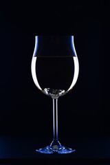 Glass of white wine on black background
