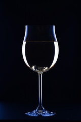 Glass of white wine on black background