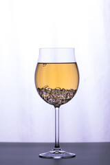 Glass of white wine on  white background