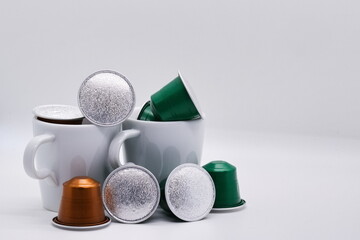 Close-up of coffee capsules and cups