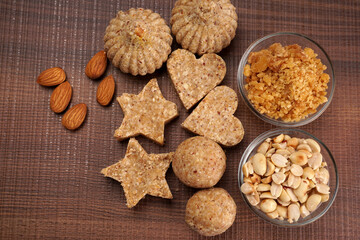 Homemade healthy and sweet groundnut or peanut and Jaggery Laddoo, delicious indian sweet served on a wooden background.Roasted peanut isolated.