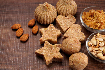 Homemade healthy and sweet groundnut or peanut and Jaggery Laddoo, delicious indian sweet served on a wooden background.Roasted peanut isolated.