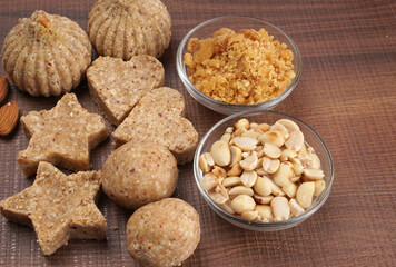 Homemade healthy and sweet groundnut or peanut and Jaggery Laddoo, delicious indian sweet served on a wooden background.Roasted peanut isolated.