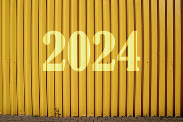 2024 new year inscription on empty yellow colored high fence made from steel sheet front view on...