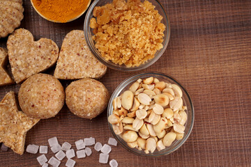 Homemade healthy and sweet groundnut or peanut and Jaggery Laddoo, delicious indian sweet served on a wooden background.Roasted peanut isolated.