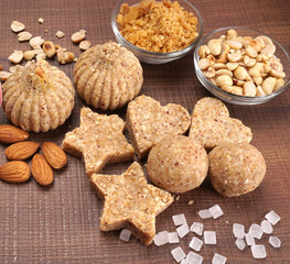 Homemade healthy and sweet groundnut or peanut and Jaggery Laddoo, delicious indian sweet served on a wooden background.Roasted peanut isolated.