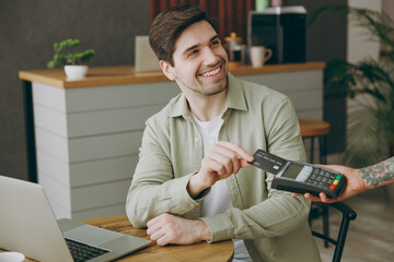 Young man wear casual clothes sitting alone at table in coffee shop cafe indoor work laptop pc...