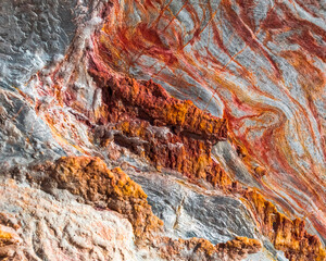 Moving colours. A close-up of a sandstone cutting on Robinson Pass, Western Cape. - obrazy, fototapety, plakaty