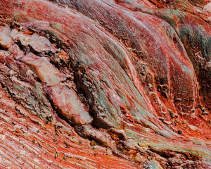 Red swirls. A close-up of a sandstone cutting on Robinson Pass, Western Cape. - obrazy, fototapety, plakaty