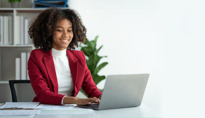 African american businesswoman sitting and recording data details in financial business Online...