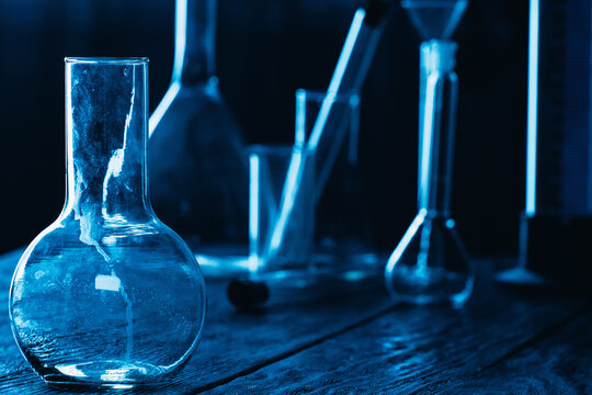 Photo of glass flasks and test tubes on dark background..
