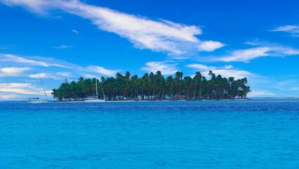 the beautiful view of an island on a clear day in the water