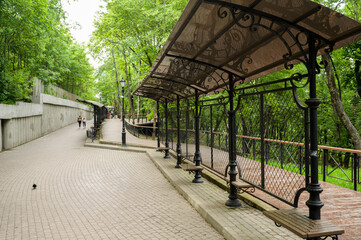 landscaped walking path with seating, pedestrian path