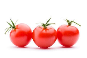Small red cherry tomatoes on white background.