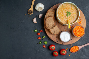 top view lentil soup with salt raw lentils and dark bread loafs on dark surface diner dinner horizontal food colourful meal dish bread