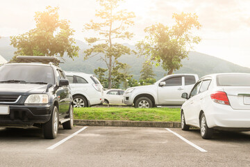 Car parked in asphalt parking lot and empty space parking  in nature with trees and mountain background .Outdoor parking lot with fresh ozone and eco friendly green environment concept