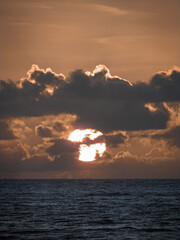 Sunrise among the clouds with the ocean