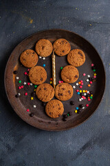 top distant view delicious chocolate cookies inside dark round plate on the dark background cookie biscuit sweet tea