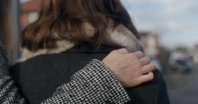 CU TS Female couple embracing and walking outdoors