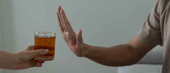 man refuses say no and avoid to drink an alcohol whiskey , stopping hand sign male, alcoholism...
