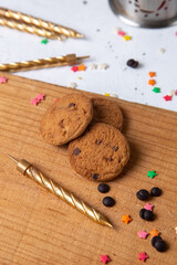 top view chocolate cookies baked and delicious with little star signs and candles on the light desk biscuit cake sweet sugar tea