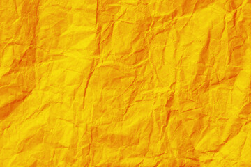 Wrinkled yellow paper texture background. Crumpled paper surface.