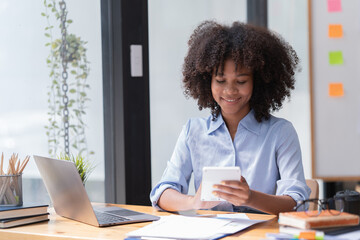 Female Entrepreneur. Cheerful African American Businesswoman Working On document and Laptop In Modern Office. Empty Space